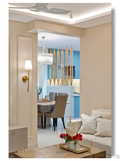 A detail shot showing the connection between the living and dining areas. The composition highlights the use of a decorative wooden partition to create a sense of separation while maintaining an open feel.