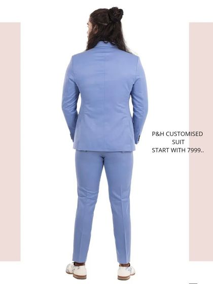 A view from the back of the light blue suit, demonstrating the clean and precise tailoring across the shoulders and back.