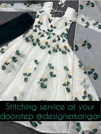 A white Anarkali suit fabric with a green and yellow floral print. Our stitching service can turn this into a beautiful custom outfit.