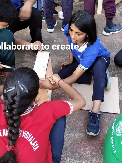 Collaborate to create. Students working together, holding pieces in place for each other, is a key part of our group workshop experience.