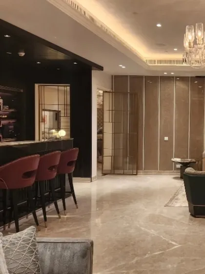 This view shows how the living area flows into the bar. I designed this space to be both open for entertaining and zoned for intimacy, using furniture and lighting to define each area's purpose.
