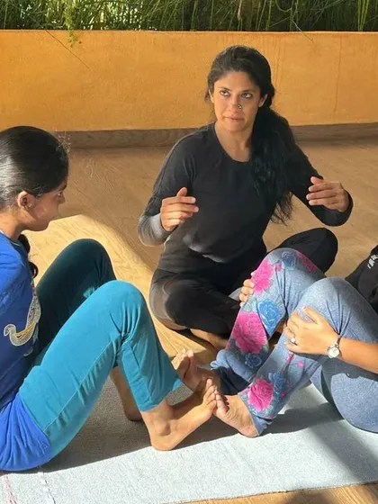 In my workshops, I guide students on how to support each other. Here, we are working on a gentle assisted stretch, which allows for a safe release of tension in the back and shoulders.