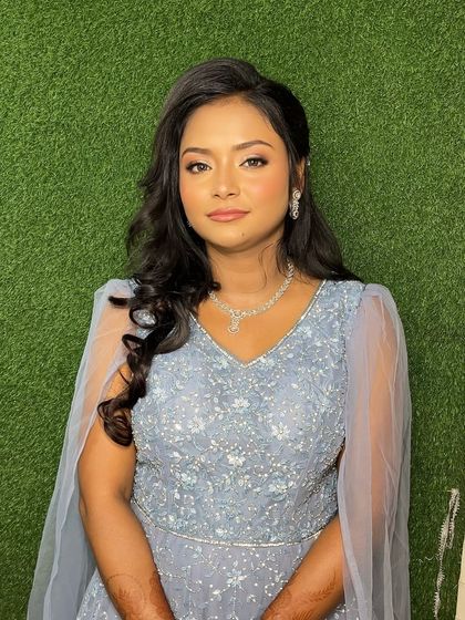 A portrait shot that captures the essence of "less is more." Her skin looks radiant and the makeup is perfectly blended for a seamless finish.