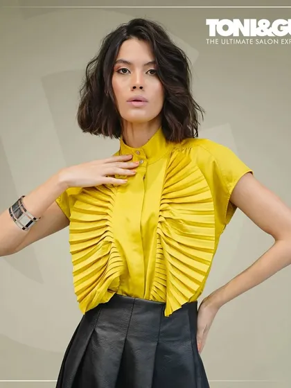 This is the result of world-class training. A model showcases a forward graduation haircut with textured layers, a look created during a masterclass to demonstrate how advanced techniques can highlight features and create beautiful movement.