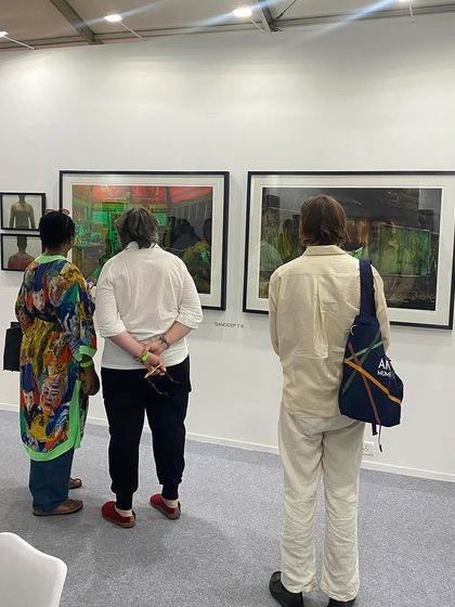 A group admiring the powerful photography of Sandeep TK.