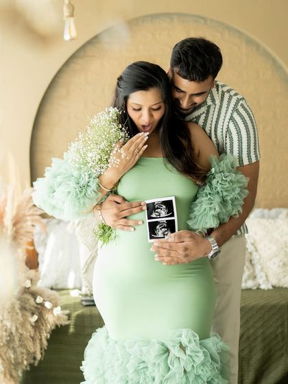A moment of pure surprise and joy as the couple looks at their sonogram picture together.