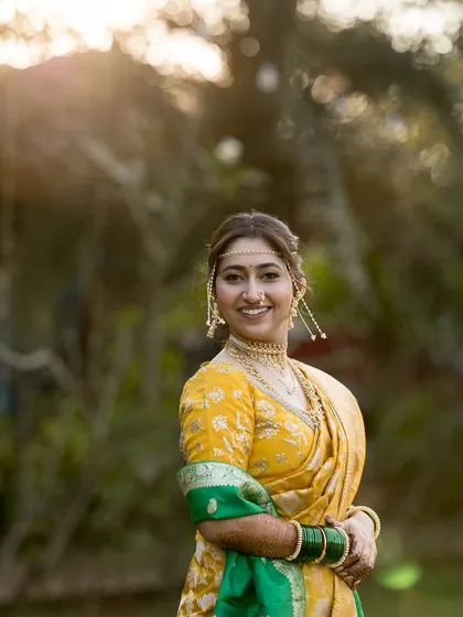 A happy, smiling portrait of the bride in a beautiful garden setting.
