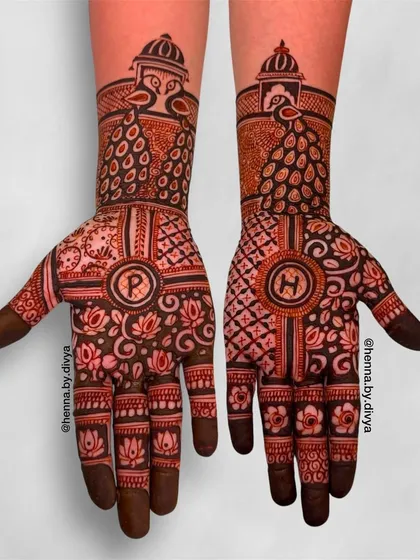 A personalized design with the couple's initials, 'P' and 'H', at the center of each palm. The design is complemented by peacock and floral motifs.