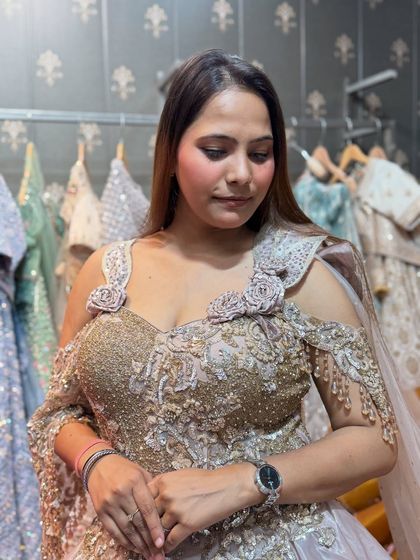 A close-up of the intricate handwork on our champagne-colored gown. The off-shoulder design with floral details is both romantic and stylish.