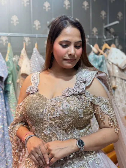 A close-up of the intricate handwork on our champagne-colored gown. The off-shoulder design with floral details is both romantic and stylish.