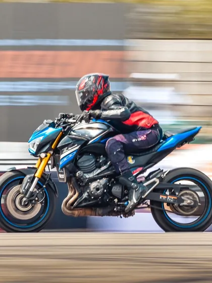 A blue Kawasaki Z800 at speed. Even streetfighter-style bikes are modified and brought to the strip to prove their mettle.