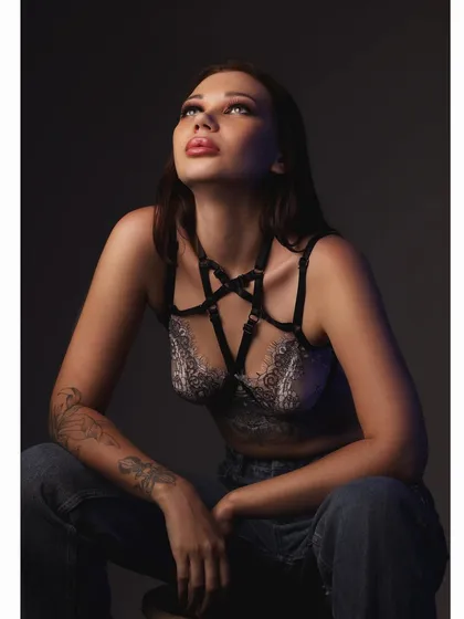 A contemplative, low-key portrait from the same series, with soft light illuminating the model from above.