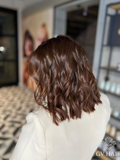 A beautiful, rich brown color on a chic, shoulder-length bob. Perfect for a sophisticated look.