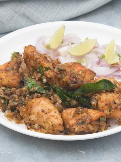 Our Pepper Fry Chicken starter. Tender pieces of chicken are pan-fried with a mix of spices, curry leaves, and onions for a flavourful dry appetizer.