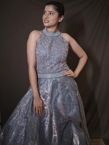 Your main character moment starts here. This grey ball gown with a heavily beaded halter-neck bodice is designed to make you steal every glance.