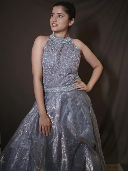 Your main character moment starts here. This grey ball gown with a heavily beaded halter-neck bodice is designed to make you steal every glance.