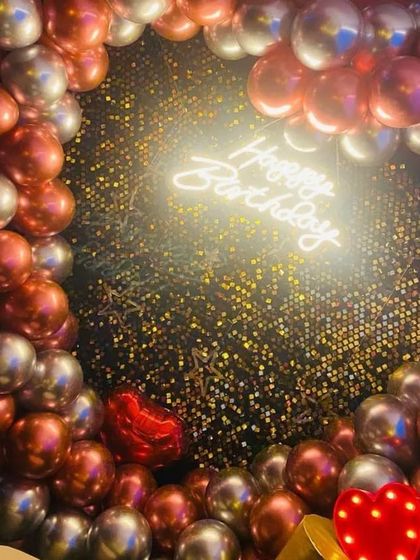 This is one of my most popular birthday designs, featuring a dense arch of metallic balloons around a glittering sequin wall with a central neon sign.
