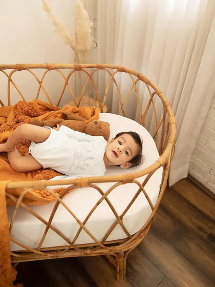 A quiet moment in the bassinet. Even during a playful sitter session, we capture the calm, curious expressions that show your baby's developing personality.