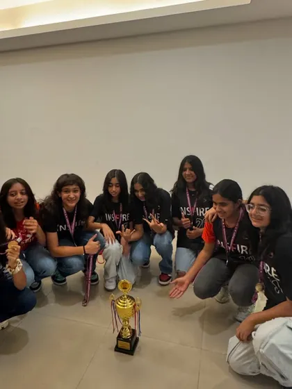 Posing with the prize. The team gathers around their trophy after a hard fought tournament win.