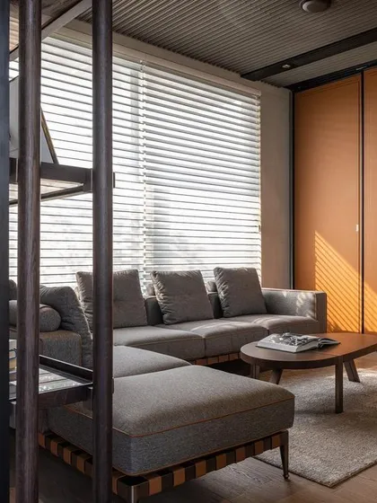 Another view of the executive lounge, highlighting the warm color palette with tan leather closet panels and a textured ceiling, creating a sophisticated and comfortable environment.