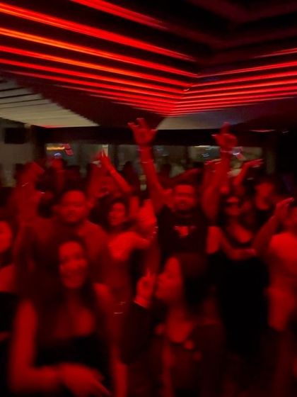 The red lights and packed floor at NYX create an intense party atmosphere.