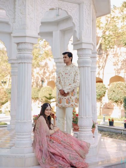 A beautifully composed portrait of the couple in a marble gazebo, capturing a moment of serene togetherness during their Mehendi.