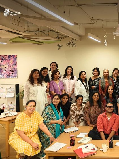 A group of smiling educators and parents pose together after a fulfilling workshop. These sessions build a strong community of practice where like-minded individuals can connect, share experiences, and support one another.