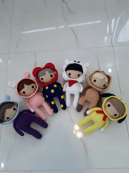 A full set of handmade BTS-inspired dolls, each wearing a different cute animal onesie. These are very popular among fans.