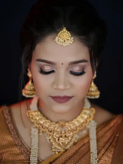 A close-up of the eye makeup for the South Indian look. The soft brown and gold tones are classic and elegant, perfect for a traditional bride.