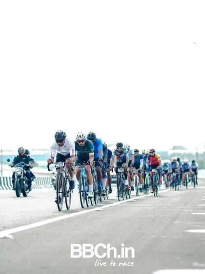The peloton from a distance, showing the race unfolding on the open road.