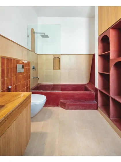 I use color and material to create immersive experiences. This bathroom is a celebration of craftsmanship, featuring a handcrafted bathtub made from red-stained cement, handmade ceramic tiles, and locally sourced Indian sandstone.