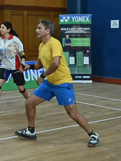 A mixed doubles pair in action during the inter-club tournament. We organize various categories to ensure wide participation, including men's, women's, and mixed doubles.