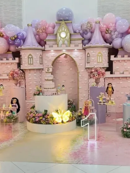 This wide shot captures the full scale of the princess castle setup, including the extensive balloon decorations on the castle towers.