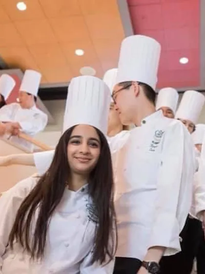 A photo from my time as a student, wearing the classic chef's toque. My training taught me the discipline and techniques that I use every day in my kitchen.