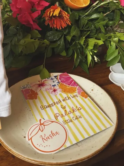 Personalized place cards and menus that perfectly match the citrus floral theme, adding a thoughtful touch to the table setting.