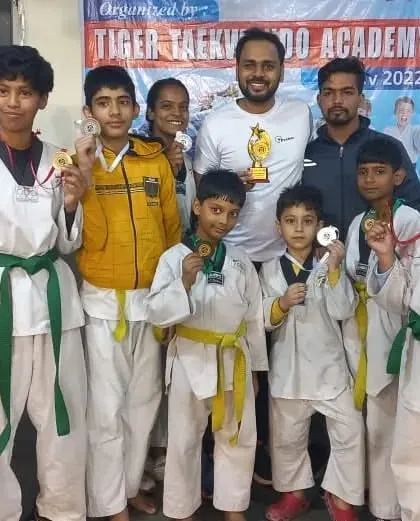 Our team proudly displaying their medals and trophy. Hard work in training translates to success in competitions.