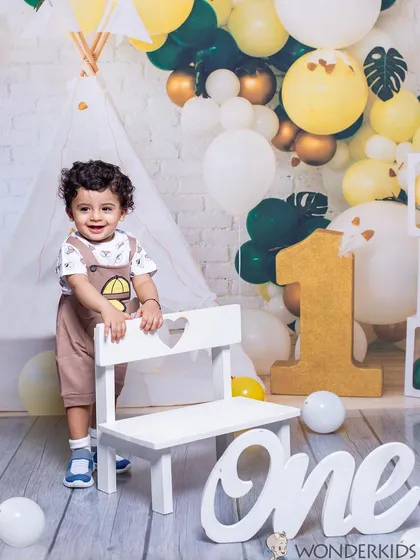Celebrating a first birthday is a huge milestone. I provide a full setup with props like this large number 'one' and a beautiful balloon arch, so you can focus on enjoying your baby's special day while I capture their happy smiles.