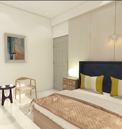 A view of the seating area in the bedroom design. A small coffee table and two chairs create a perfect spot for morning tea.