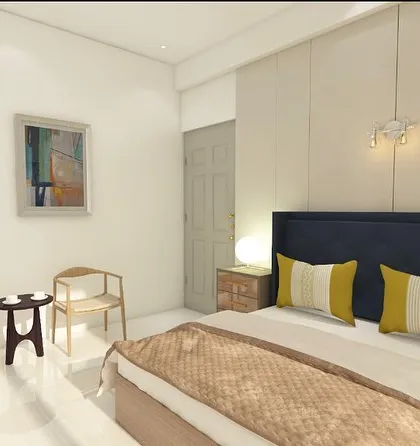 A view of the seating area in the bedroom design. A small coffee table and two chairs create a perfect spot for morning tea.