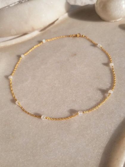 A close-up of the 'apati' Rainbow Moonstone ball choker. I love working with this stone for its ability to bring balance, harmony, and inner confidence.