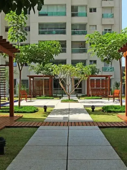Symmetrical landscape design for a large residential complex, featuring clean pathways, manicured lawns, and shaded seating areas with wooden pergolas. This demonstrates my capability to handle large-scale commercial and community projects.