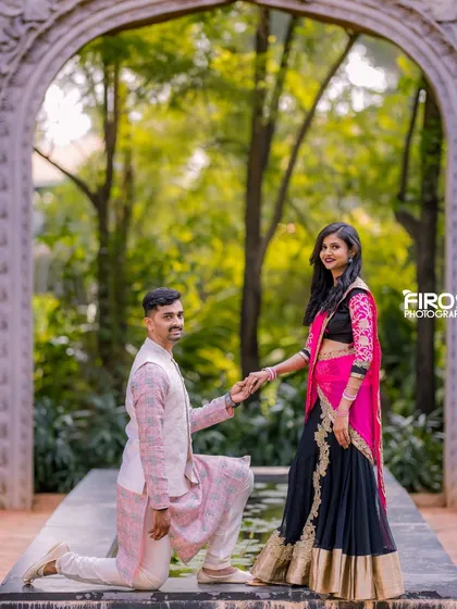 A romantic proposal pose in front of a stone archway, with the garden setting adding a natural and beautiful frame.