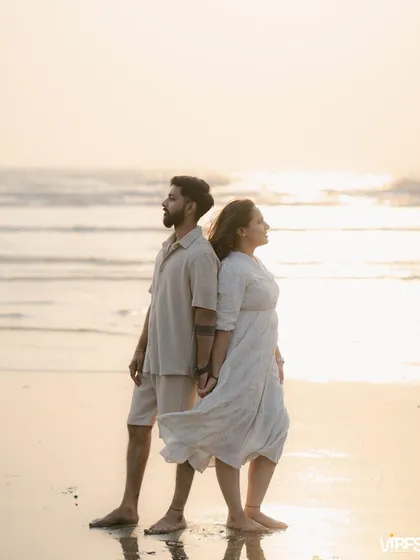 A classic back-to-back pose against the setting sun. This pre-wedding portrait has a serene and powerful feel, with the ocean as a beautiful backdrop.