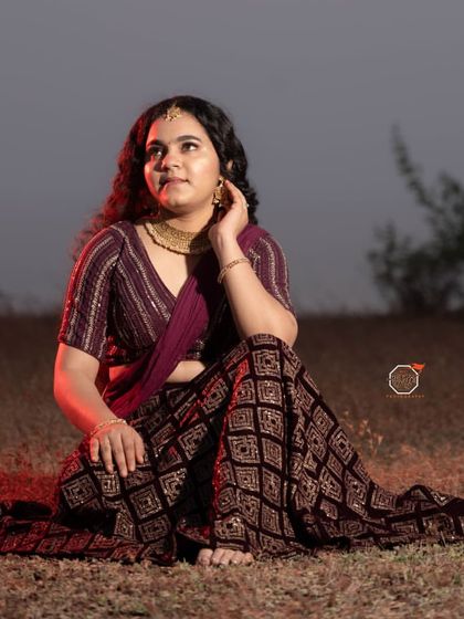 A full seated pose from my self-makeup shoot, showing how the makeup, hair, and modern saree drape come together for a complete look.