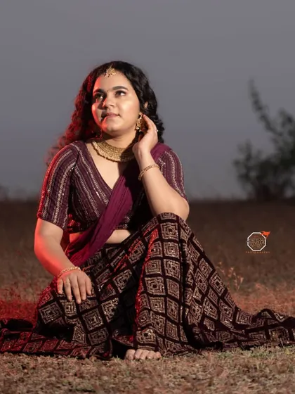 A full seated pose from my self-makeup shoot, showing how the makeup, hair, and modern saree drape come together for a complete look.
