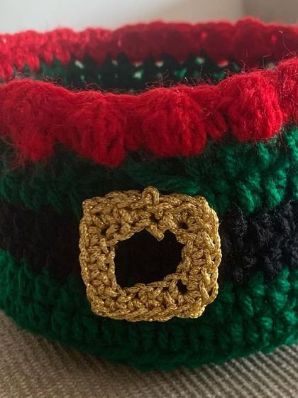 This Christmas basket features an elf-inspired color combination of green, red, and black.