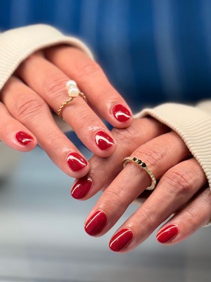 The full view of the classic red manicure. The high-gloss finish and perfect application make this simple look absolutely stunning.