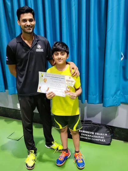 Arth Dubey with his coach after securing the runner-up position in the U-13 Boys Singles at the Raigad District Championship.