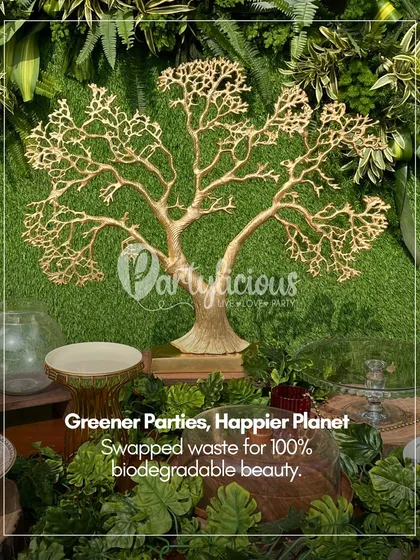Greener parties, happier planet. We swapped waste for 100% biodegradable beauty in this setup, featuring a reusable golden tree prop against a lush green wall.