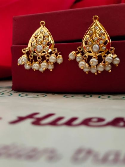 The 'कली' (Kali) gold-plated Jadau earrings. These small, bud-like danglers with pearls are perfect for a delicate and feminine look.